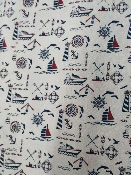 A small sailboat made of cotton and linen printed fabric in its original color A small sailboat made of cotton and linen printed fabric in its original color